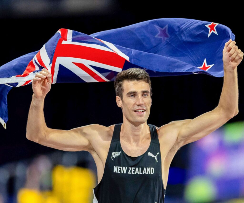 Hamish flying the New Zealand flag after his Commonwealth win