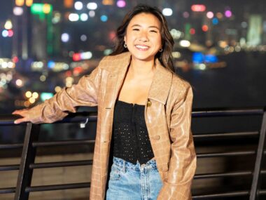 MasterChef star Mimi in front of a blurred city at night
