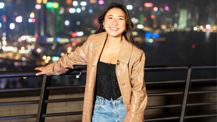 MasterChef star Mimi in front of a blurred city at night