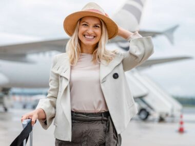 A woman smiling after her flight from using her in-flight beauty essentials