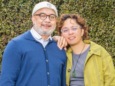 Ngā Rorirori creators Hone and Maarire in front of a hedge