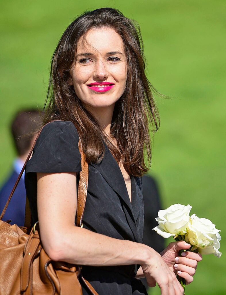 Kathleen “Kick” Kennedy holding white roses