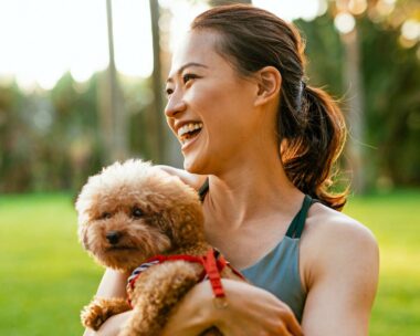 A woman holding a puppy with well-balanced hormones